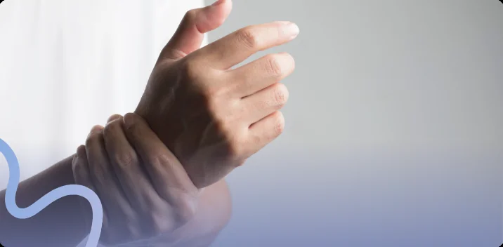 Person holding their wrist as tingling and numbness spread into their raised hand