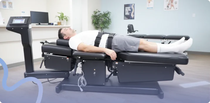 Patient lying comfortably on a spinal decompression table during a treatment session